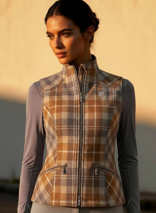 Woman wearing a plaid vest over a long-sleeve shirt with a blurred background